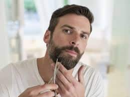 Man trimming beard to complement his face shape credit: Men's Journal