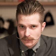 Handlebar moustache on a man with shorter hair credit: Beardbrand