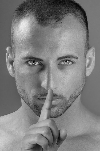 man using body language to say shhh